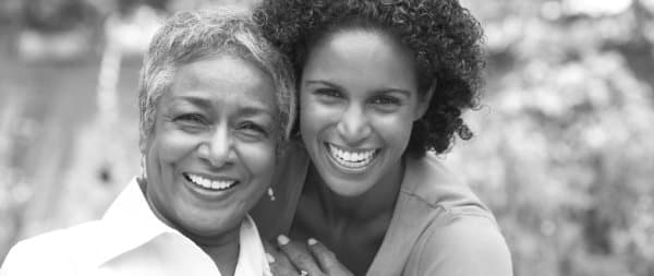 young lady and elder woman smiling