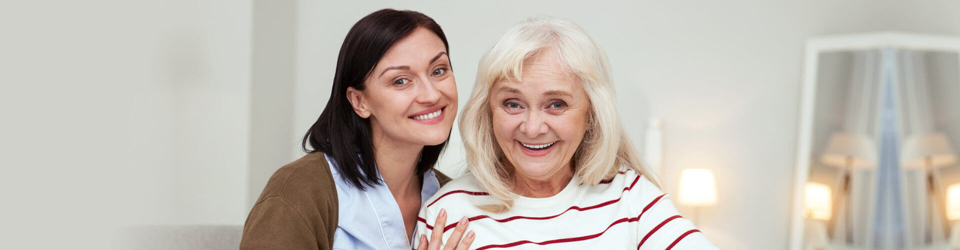 woman and senior smiling upclose